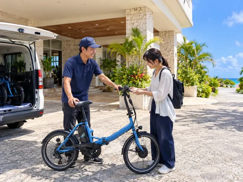 A traveler receiving a delivered bicycle at the entrance of a Miyakojima hotel