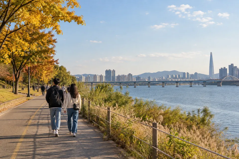 Editorial illustration of travellers strolling beside the Han River in autumn