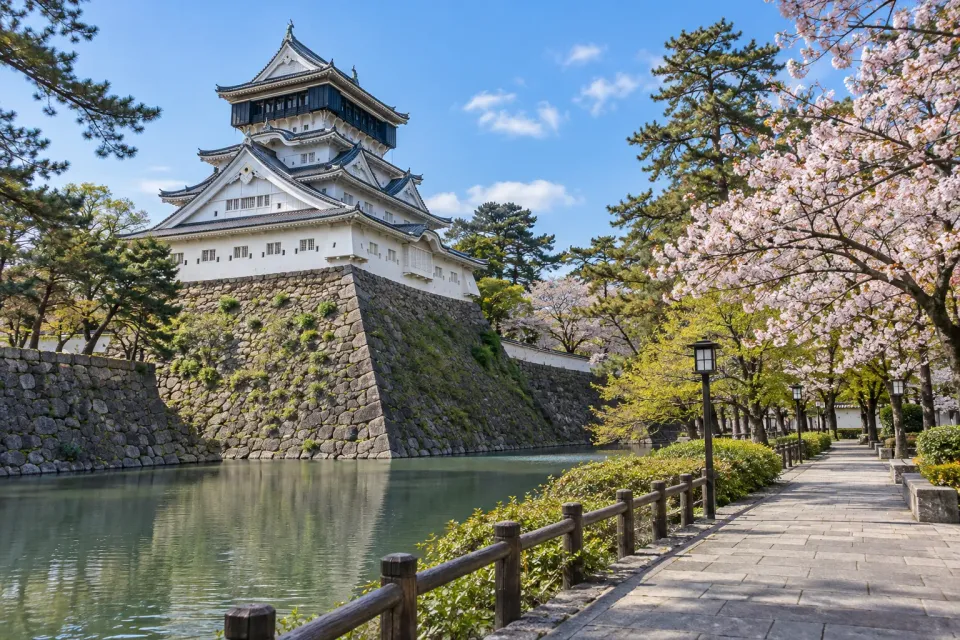 AI travel illustration inspired by Kokura Castle and its waterside setting