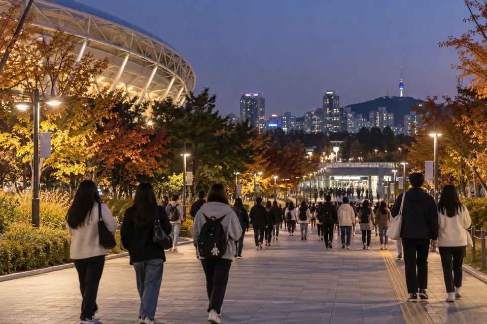 Editorial scene of a lit Olympic Park walking route used by visitors heading home after a concert